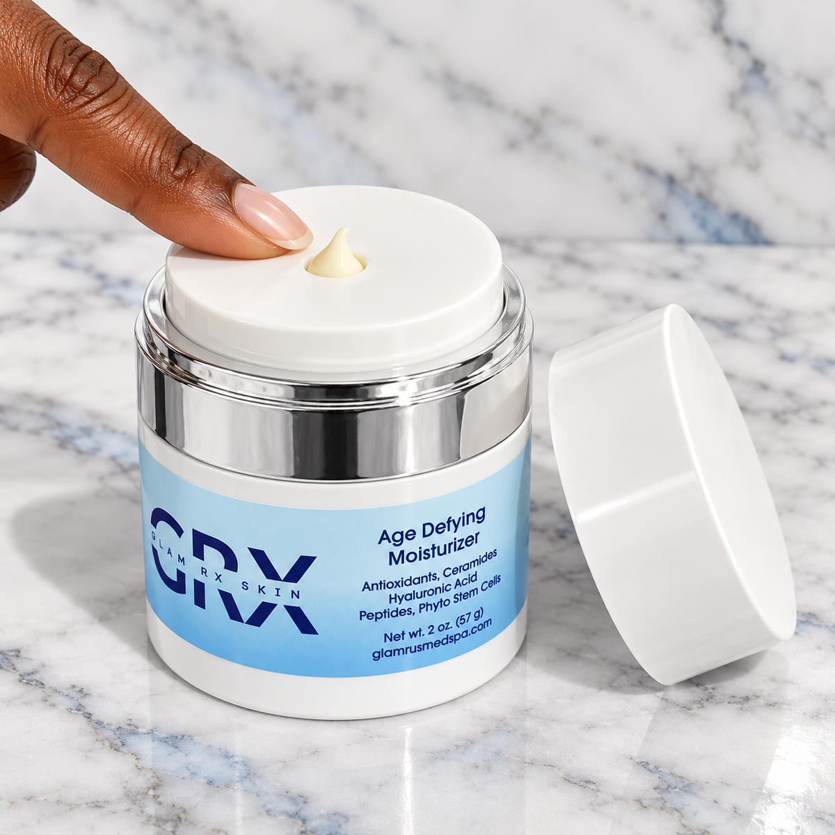 Age Defying Moisturizer — finger pressing the airless dispenser