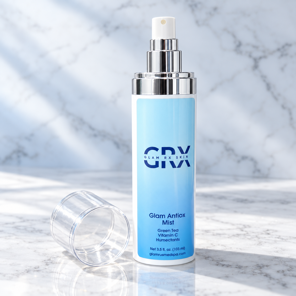Glam Antioxidant Mist with spray pump exposed and cap beside bottle